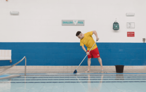 Man cleaning at a public pool